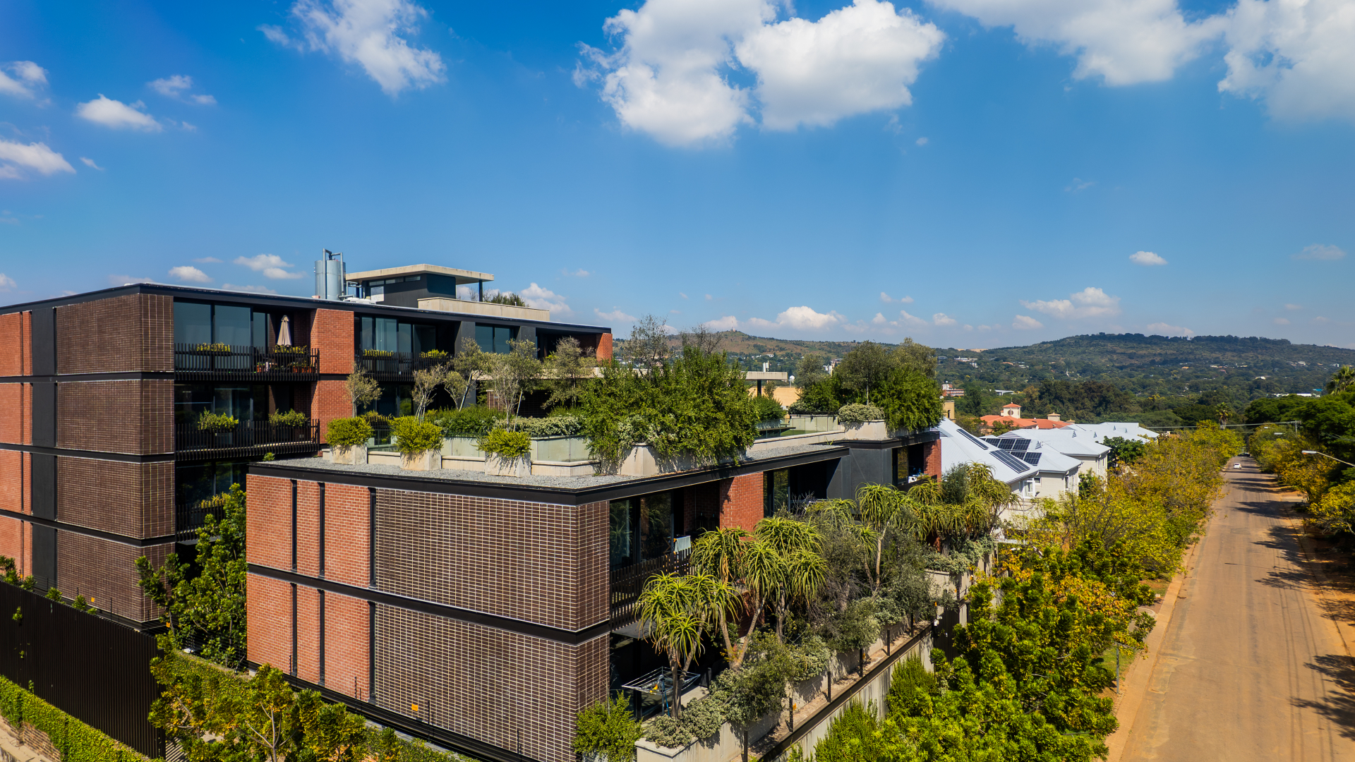 Aerial view of the building and rooftop terrace in the neighborhood