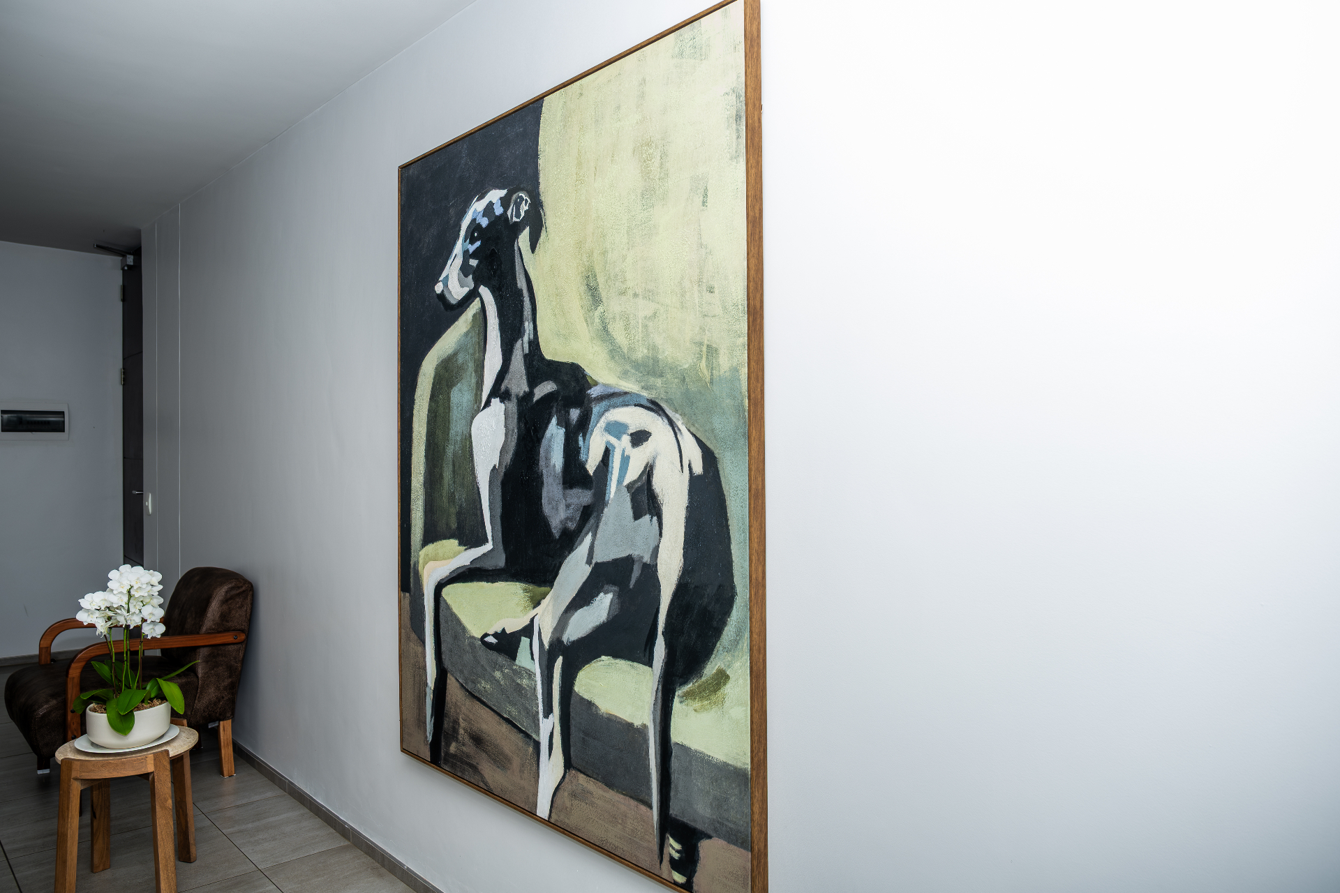 Entryway with statement greyhound artwork and orchid
