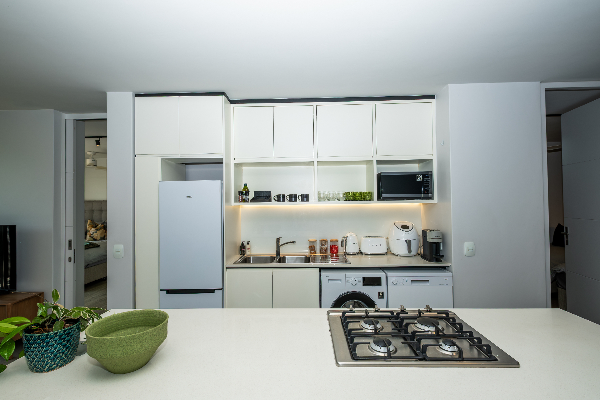 Modern kitchen with gas cooktop, island and integrated appliances