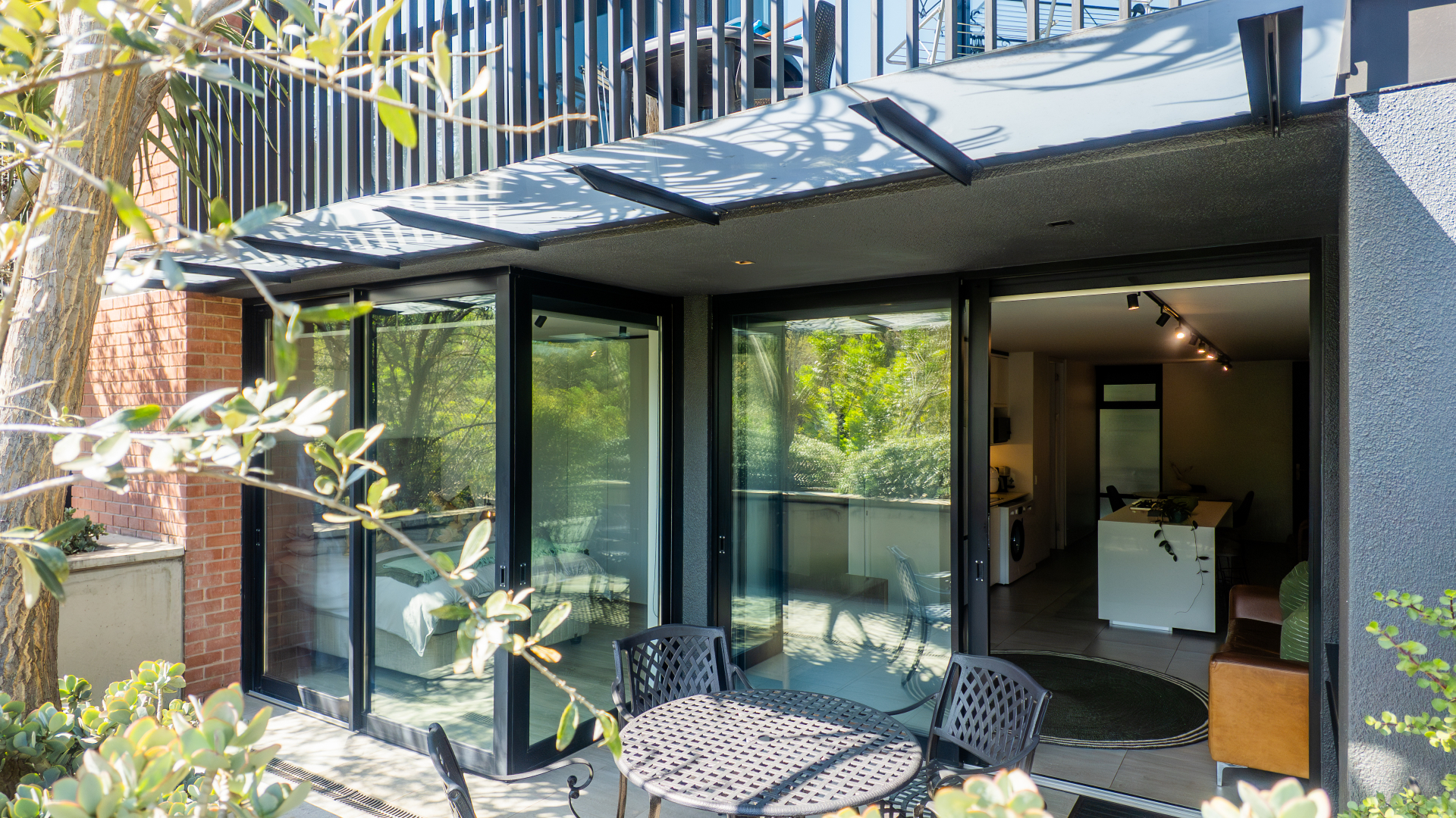 Private patio with folding glass doors opening to the garden