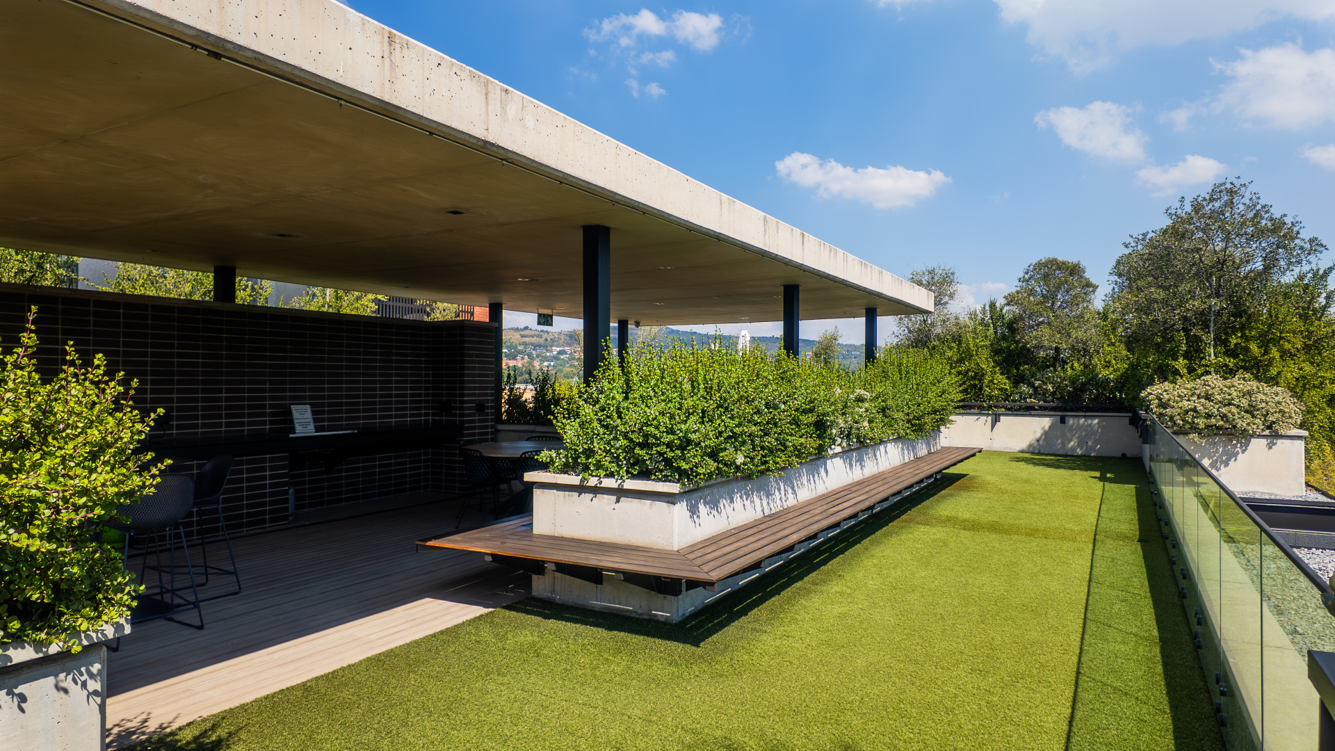 Rooftop lawn and braai area with skyline views